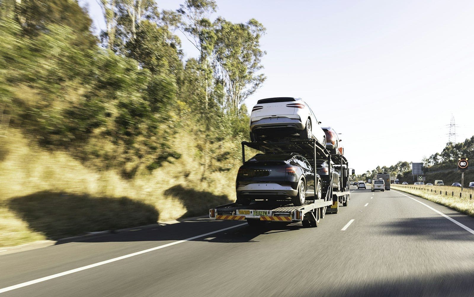 Car transporter truck carrying new vehicles on a highway